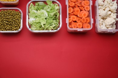 Photo of Plastic and glass containers with different fresh products on red background, flat lay. Space for text