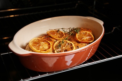 Photo of Delicious lemon chicken with thyme in oven