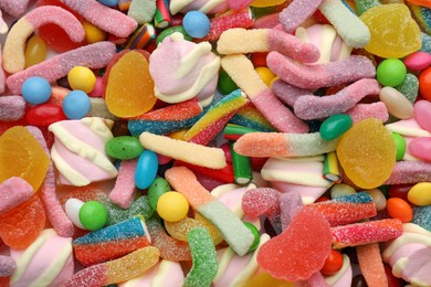 Photo of Different tasty candies as background, top view