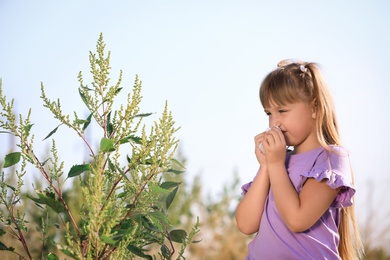 Photo of Little girl suffering from ragweed allergy outdoors