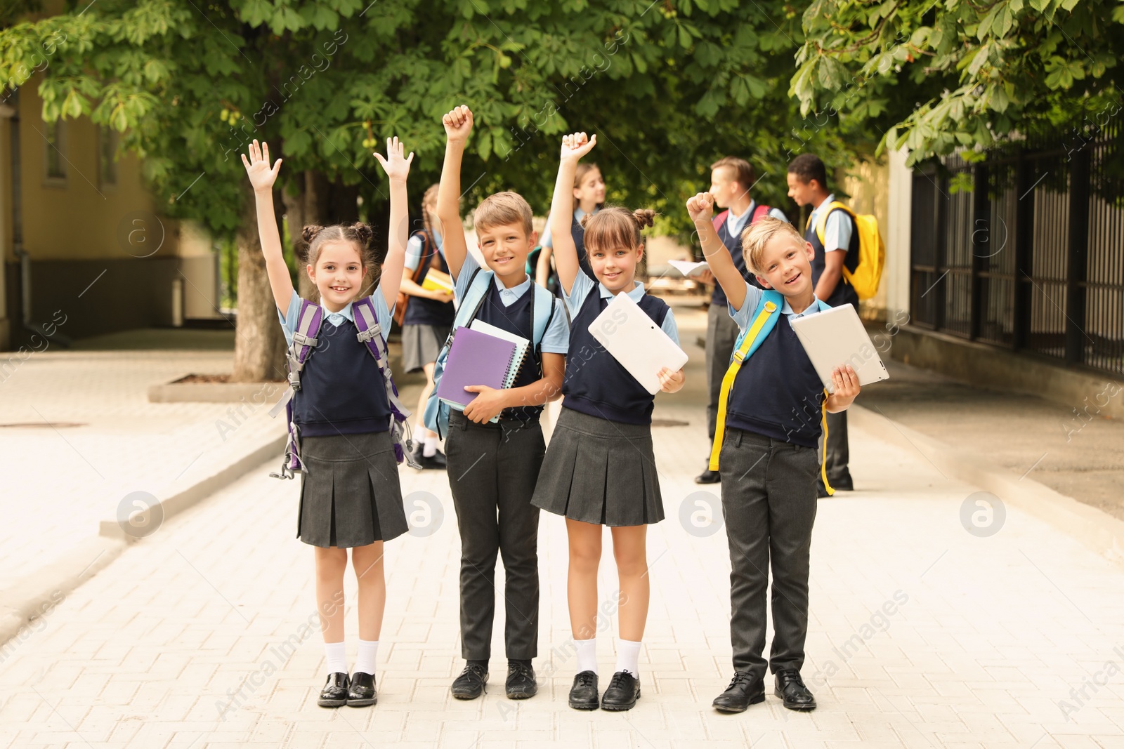 Photo of Little children in stylish school uniform outdoors