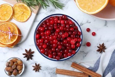 Photo of Flat lay composition with fresh ripe cranberries on white marble table