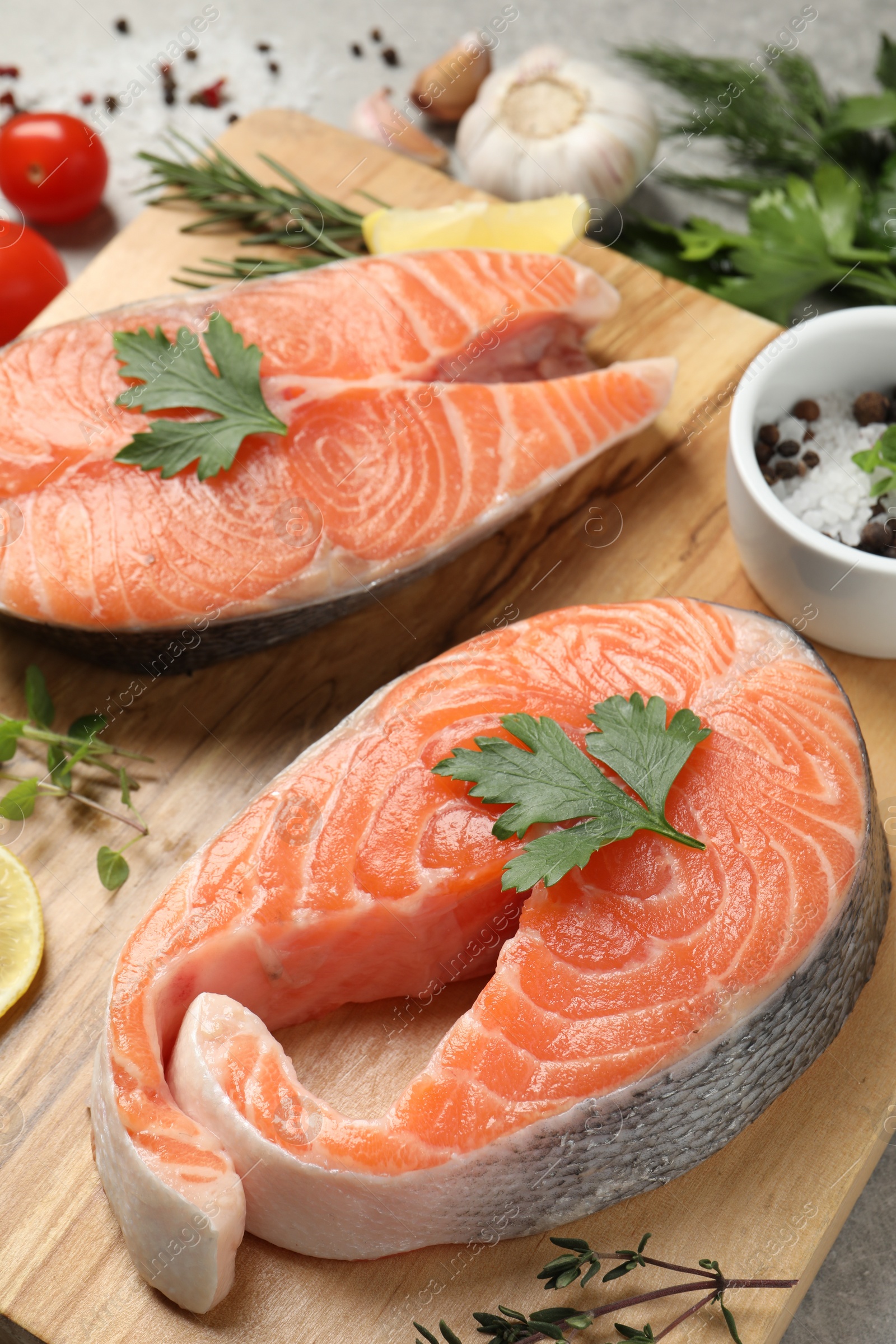 Photo of Fresh salmon and ingredients for marinade on wooden board, closeup