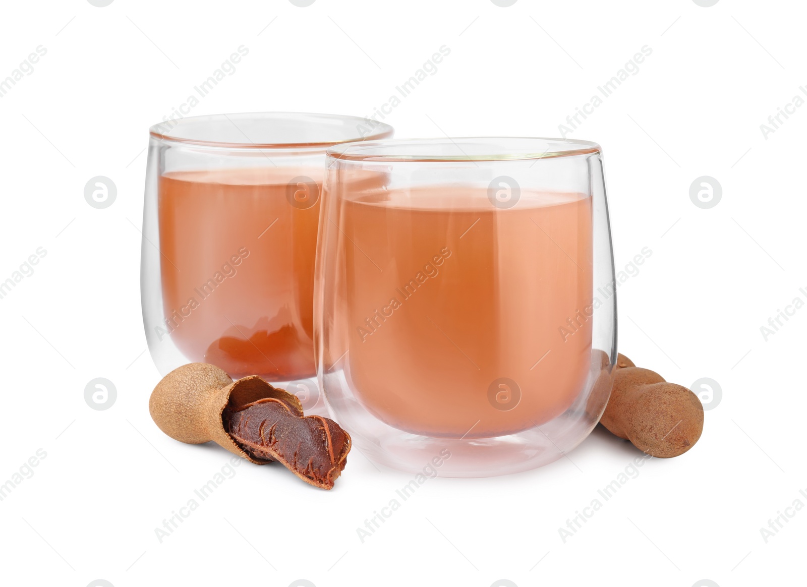 Photo of Glasses of tamarind juice and fresh fruits isolated on white