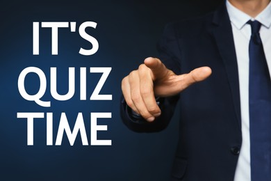 Image of Man pointing at phrase IT'S QUIZ TIME on dark blue background, closeup view