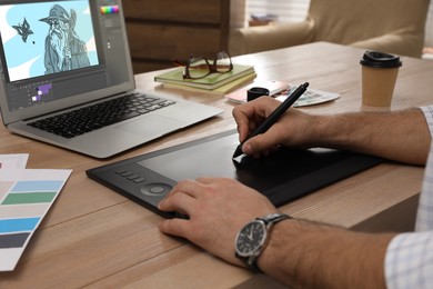 Image of Animator working with graphic tablet and laptop, closeup. Illustration on screen