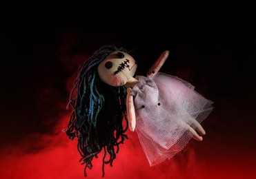 Image of Female voodoo doll with pins and smoke on dark background