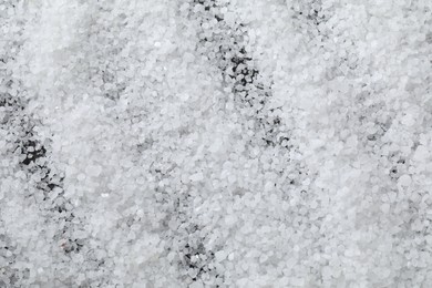 Photo of White natural salt as background, top view