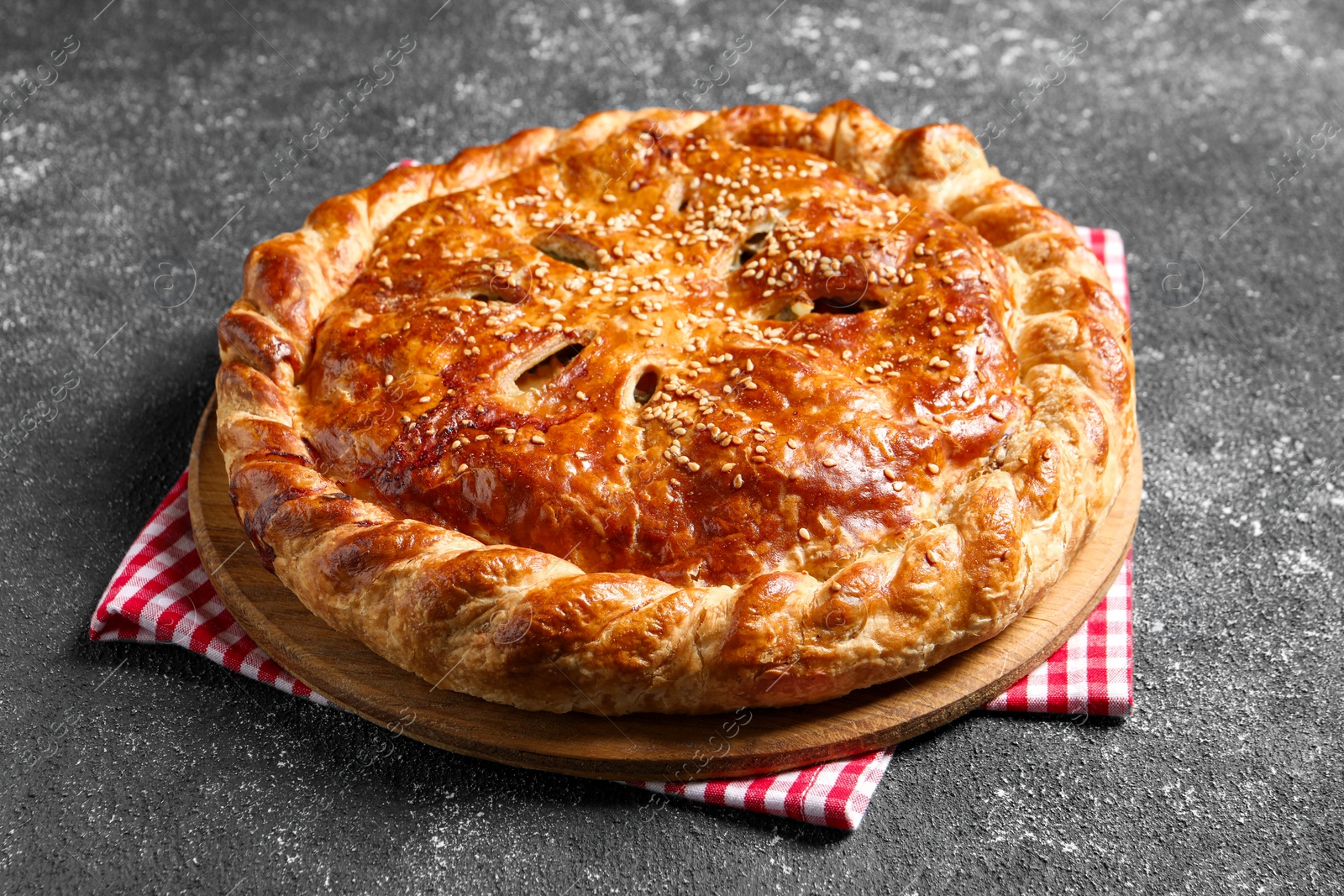 Photo of Tasty homemade pie with filling on grey table