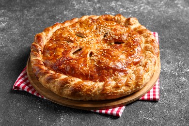 Photo of Tasty homemade pie with filling on grey table