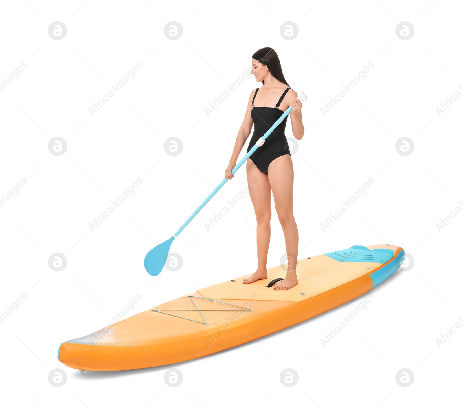 Photo of Happy woman with paddle on orange SUP board against white background