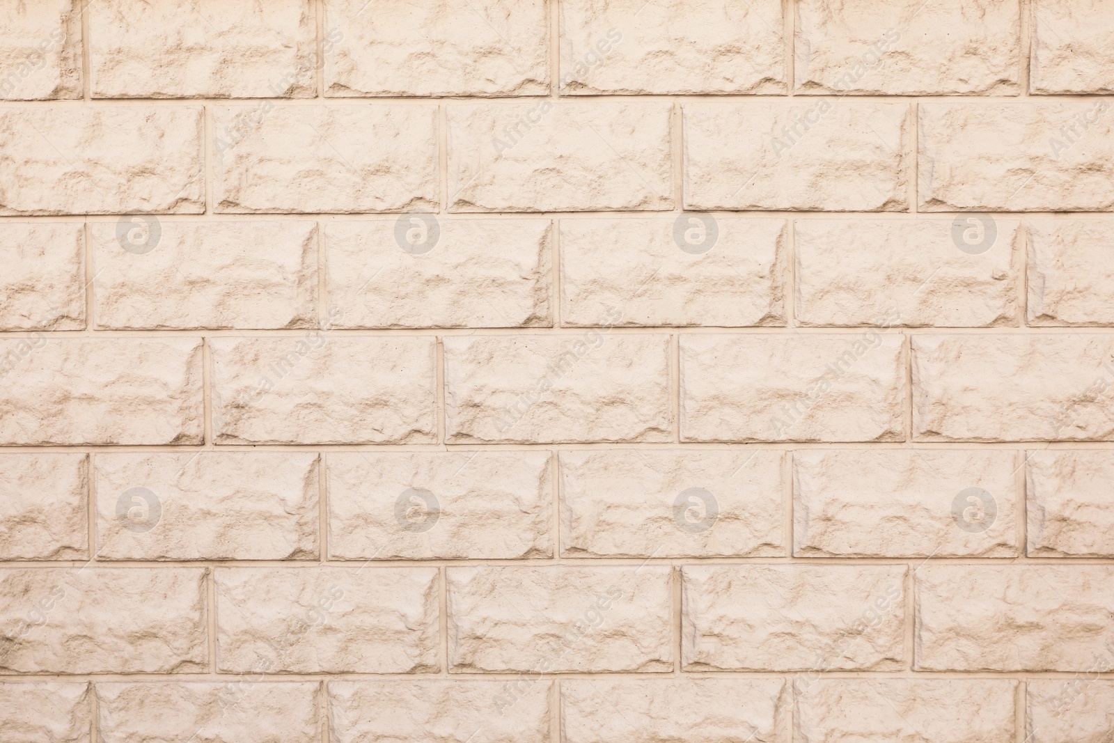 Photo of Texture of beige brick wall as background