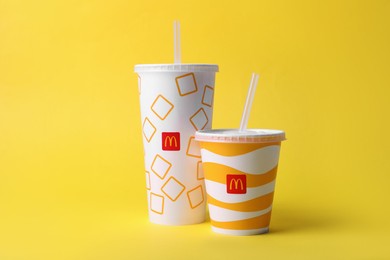 MYKOLAIV, UKRAINE - AUGUST 12, 2021: Cold McDonald's drinks on yellow background