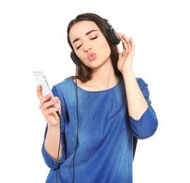 Beautiful young woman listening to music on mobile phone against white background