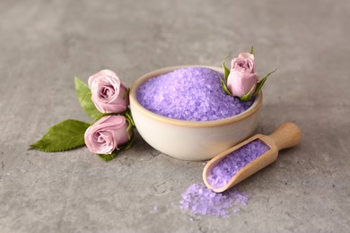 Photo of Purple sea salt and beautiful flowers on light grey table