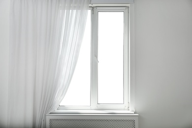 Photo of Light room with window and open curtains. Home interior