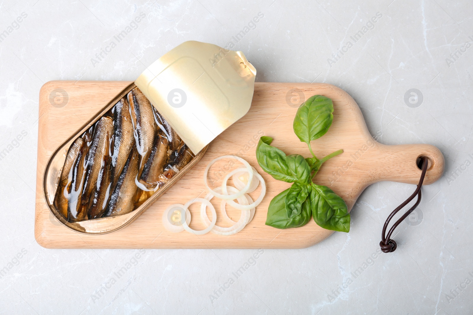 Photo of Flat lay composition with canned fish on light background