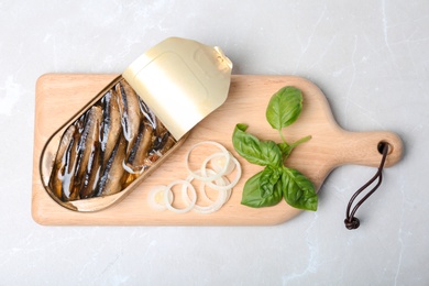 Flat lay composition with canned fish on light background