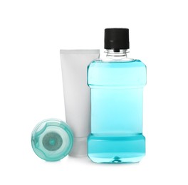 Photo of Mouthwash, dental floss and toothpaste on white background