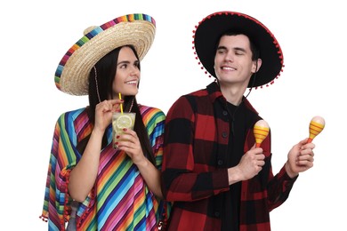 Photo of Lovely couple in Mexican sombrero hats with cocktail and maracas on white background