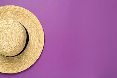 Stylish straw hat on purple background, top view. Space for text