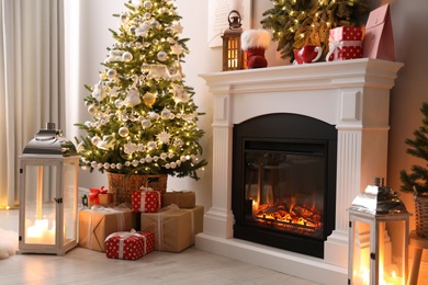 Beautiful fireplace, Christmas tree and other decorations in living room. Interior design