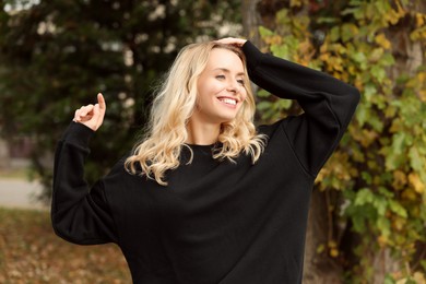 Happy woman in stylish warm sweater outdoors