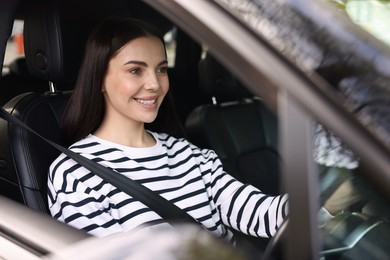Photo of Woman with safety seat belt driving her modern car