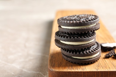 Photo of Board with chocolate cookies on table. Space for text