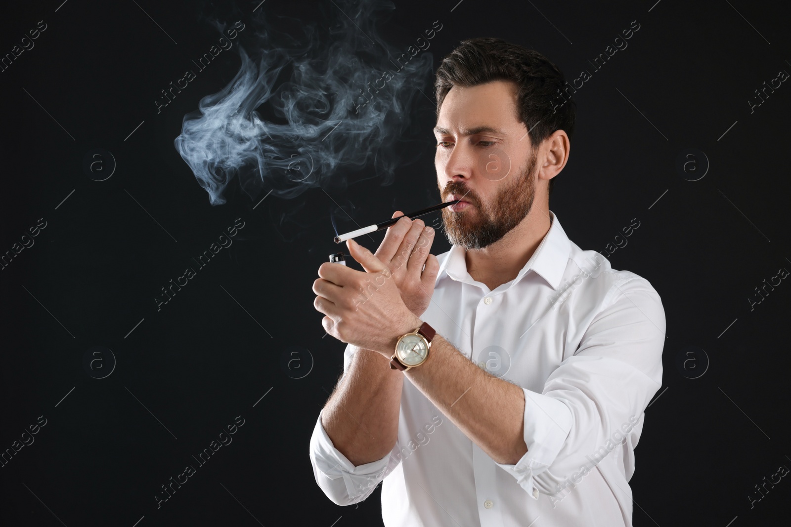 Photo of Man using long cigarette holder for smoking on black background, space for text