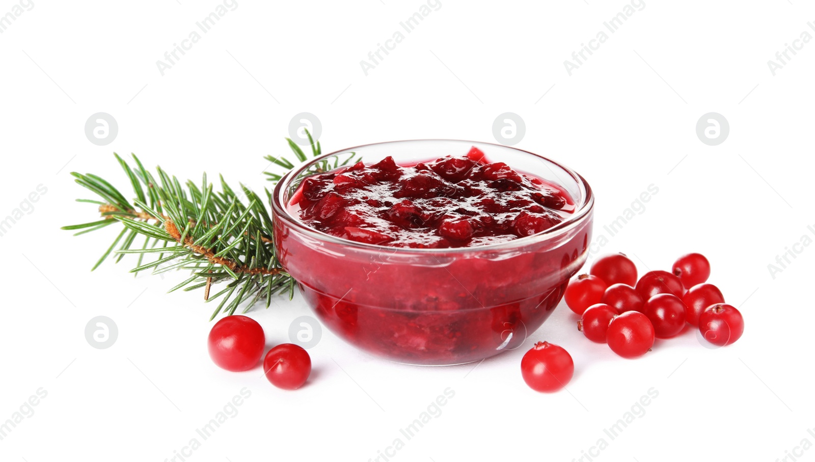 Photo of Bowl of cranberry sauce with fir tree branches on white background