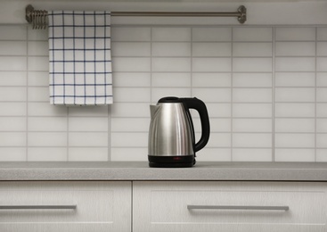 Photo of Modern electric kettle on grey kitchen counter
