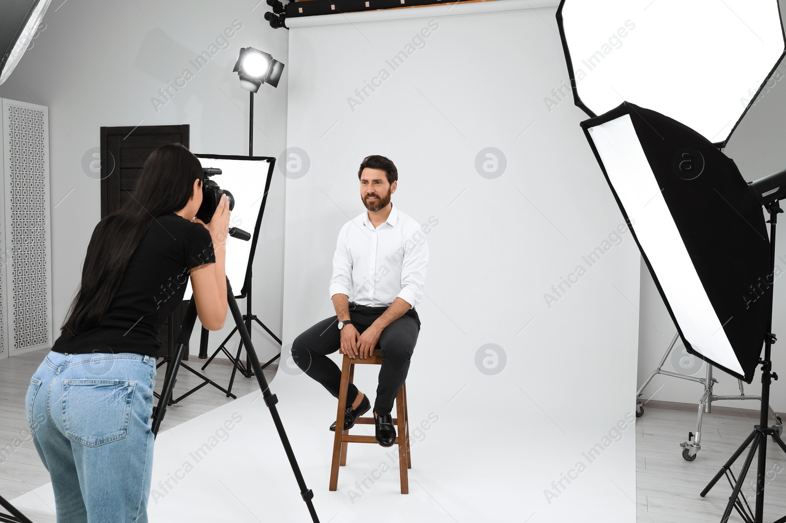 Photo of Handsome model posing for professional photographer in studio