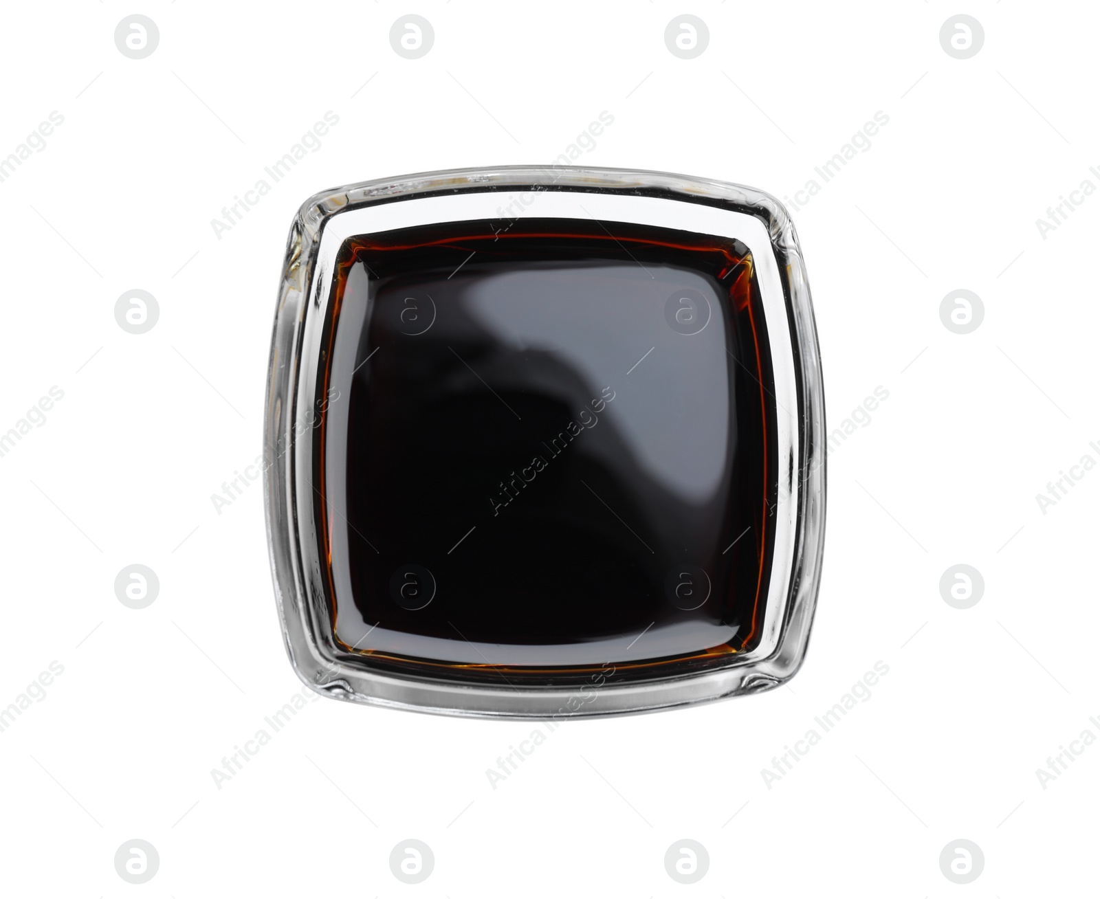 Photo of Bowl of tasty soy sauce isolated on white, top view