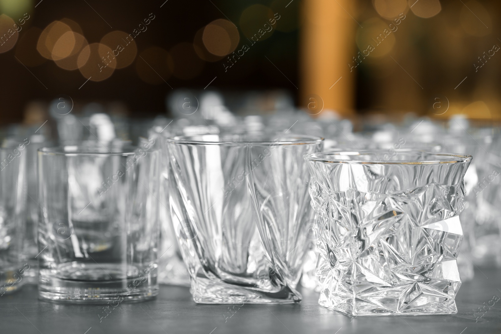 Photo of Empty glasses on table against blurred background