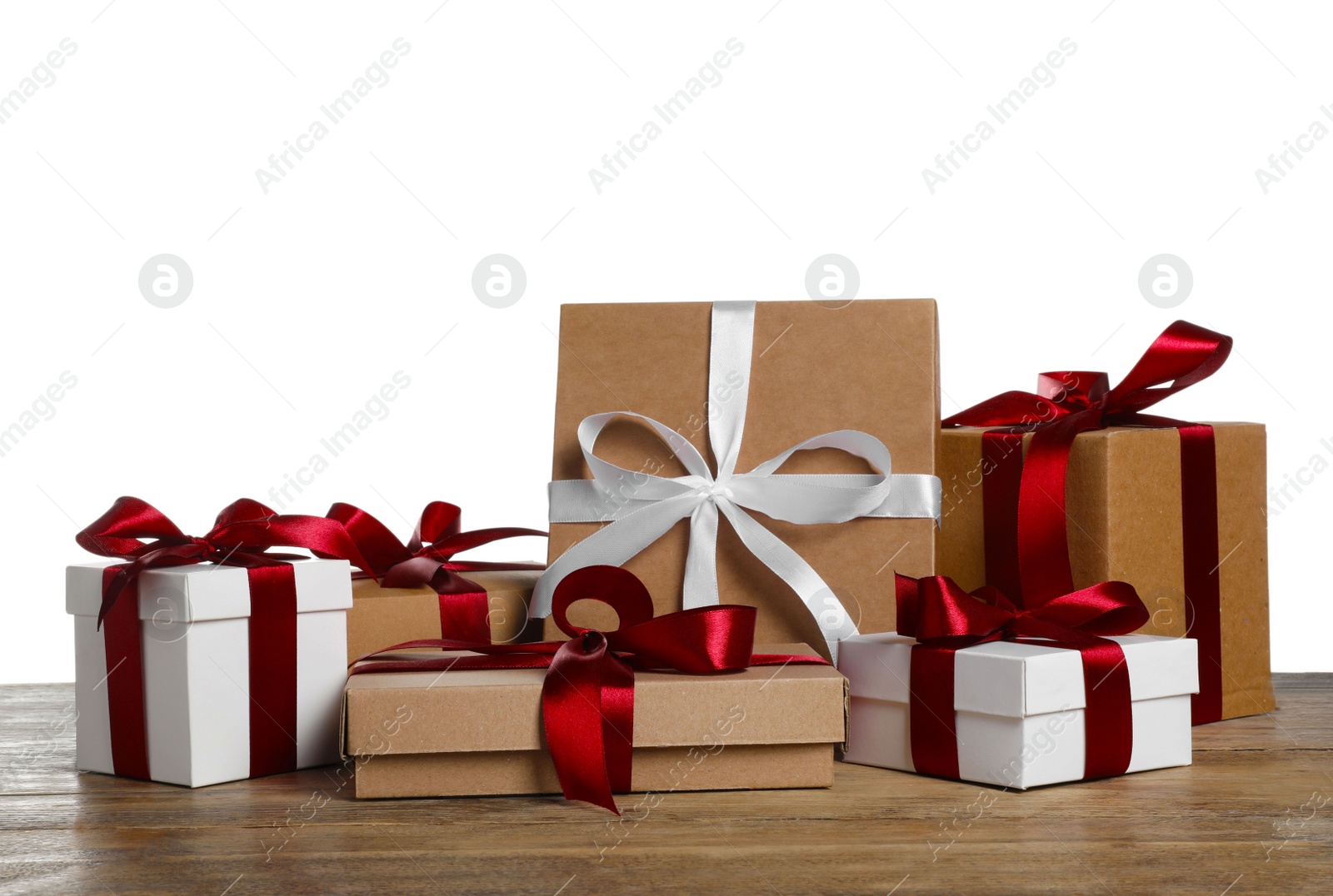 Photo of Different Christmas gifts on wooden table against white background