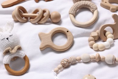 Many different baby accessories on white fabric