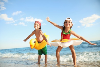 Photo of Cute children enjoying sunny day at beach. Summer camp