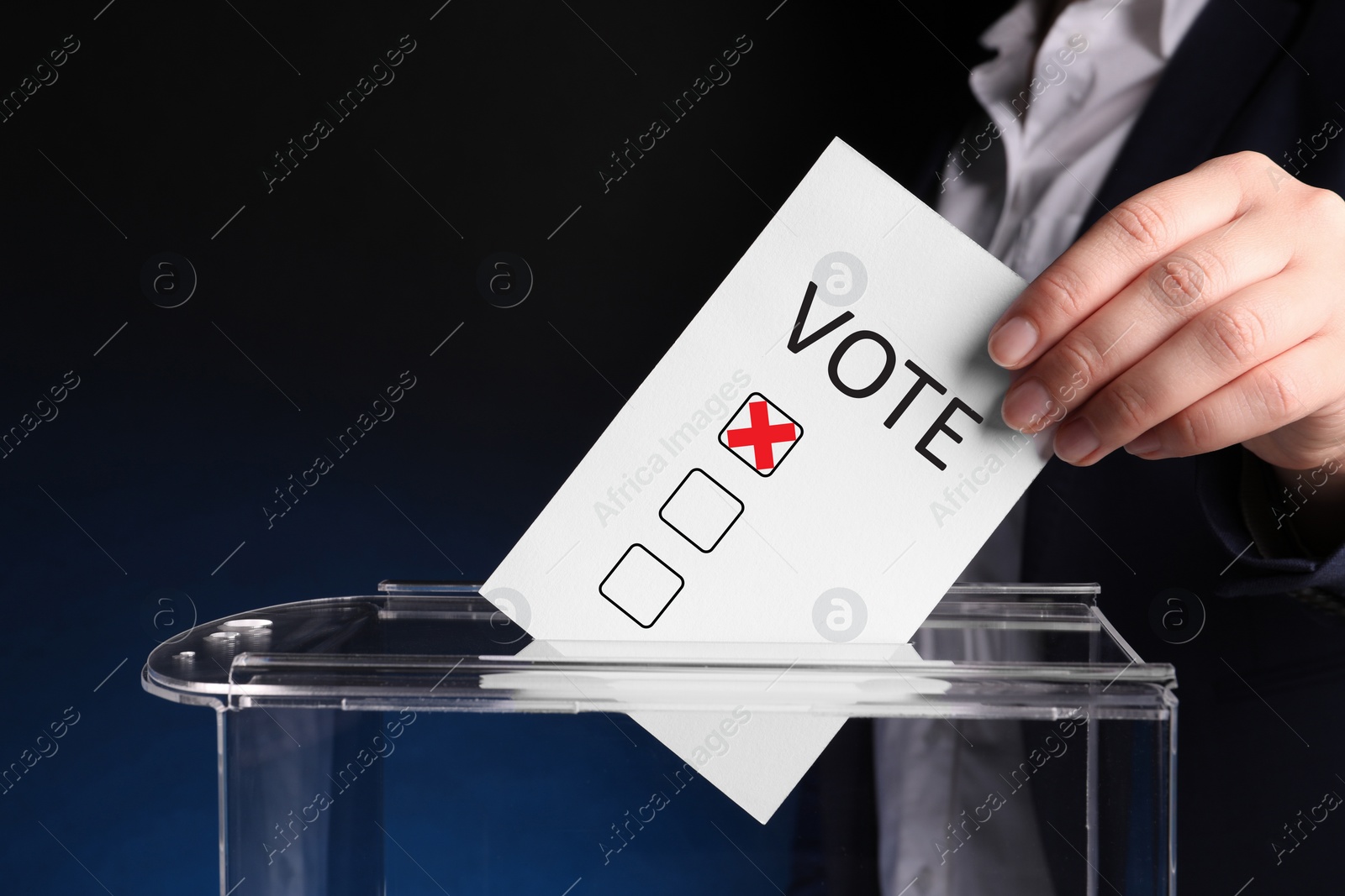 Image of Woman putting paper with word Vote and tick into ballot box on dark blue background