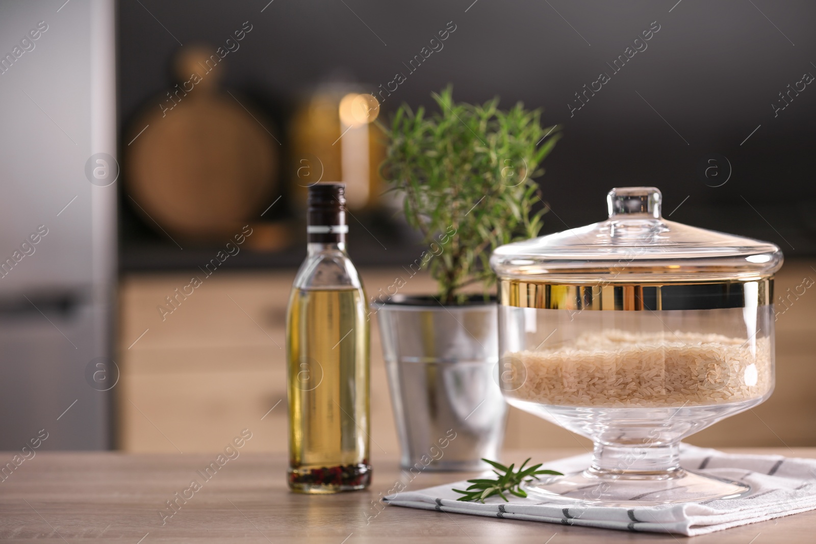 Photo of Jar with rice on wooden table in modern kitchen