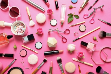 Flat lay composition with products for decorative makeup on pink background