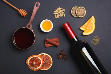 Photo of Flat lay composition with ingredients for mulled wine on black background