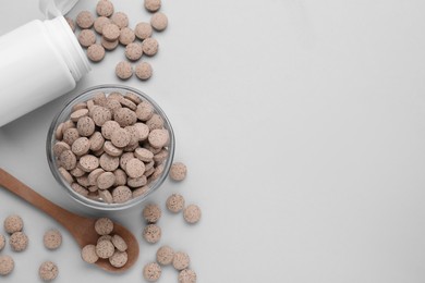 Photo of Flat lay composition with brewer`s yeast tablets on light grey background. Space for text
