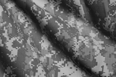 Image of Texture of crumpled camouflage fabric as background, top view. Black and white effect