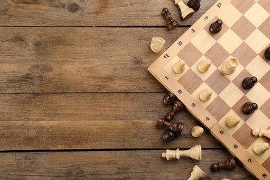 Photo of Flat lay composition of chess on wooden table, space for text. Board game