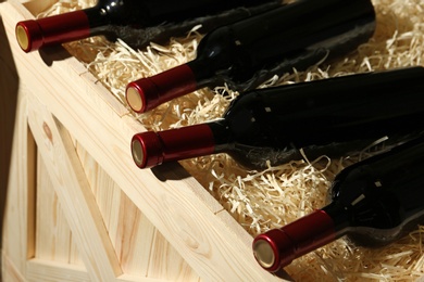 Wooden crate with bottles of wine, closeup