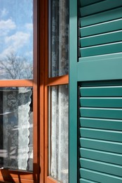 Photo of Window with vintage wooden shutters outdoors, closeup