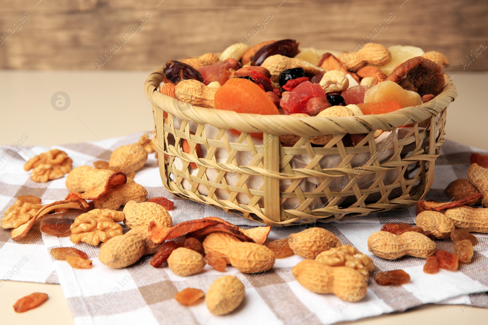 Photo of Mixed dried fruits and nuts on beige background