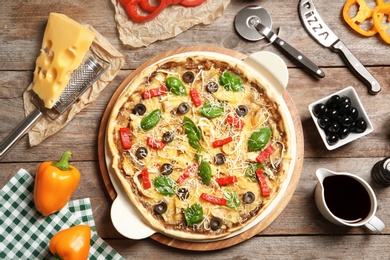 Photo of Flat lay composition with delicious homemade pizza and ingredients on wooden background