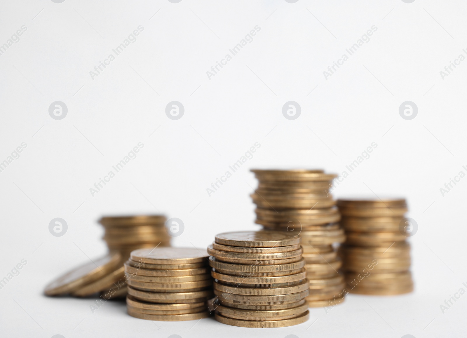 Photo of Many Euro coins stacked on white background